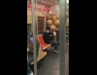 Guy Carries White and Gold Balloons on Subway Ride 