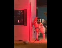 Two large women puts whipped cream on the butt