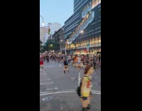 Mob crowd of skaters and bikes on street