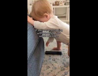 Baby struggle to pick up the remote