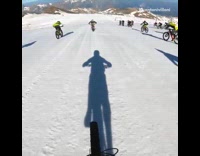 Mountain biker rides down trail on race 