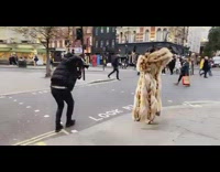 Woman in removes fur coat and poses in the street