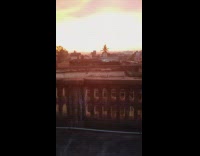 Guy barefoot on rooftop show sunset sky