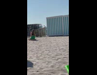 Ladies Dance to Music on Beach as Friend Records