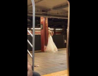 Woman wear white gown in subway station