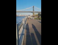 Man in gray shirt jogs for a video shoot at the park