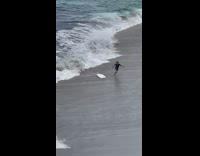 Guy fails to pull boogie board toward shore 