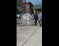 Woman stands in seethrough ball 