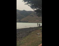 Girl on swing by lake