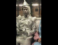 Two Wizard of Oz characters sit next to each other on subway 