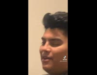 Guy in green shirt sitting in chair staring at camera