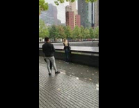 Girl poses in front of memorial 