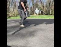 Guy grey sweats black shirt tries to do longboard skateboard slide fails concrete