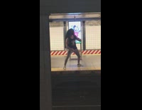 Guy sings yells and plays air drums at subway station