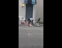 Little girl smashes doll against ground outside