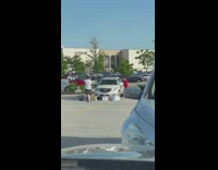 Man in front of white car with shopping bags