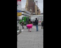 Guy wears flamingo costume while walking outside