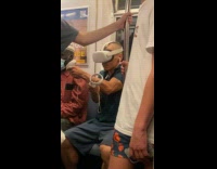 Collab WINY - Man Plays on Virtual Reality Headgear in Train