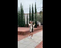 Woman in white coat spins and films herself