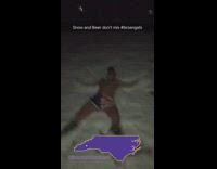Guy in hat and underwear shot guns beer and then makes snow angels 