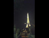 Two girls shotguns beers in front of Eiffel Tower in paris