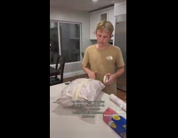 Kid wraps a bag of popcorn as his gift 