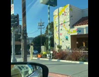 Woman yellow formal attire photo shoot Splattered paint wall