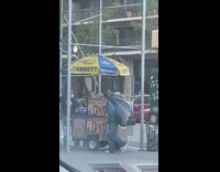 Green jacket guy black trash bag backpack 