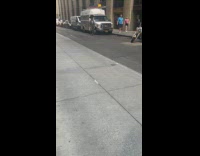 Collab WINY - Man grey suit and pants walks street balance bag on head