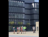 Five people dance courtyard neon green shirt 