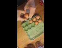 Man cracks eggs with double yolk