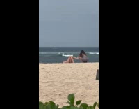 Woman lie down holds glass at beach
