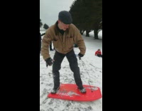 MUSIC man boogie boards down snowy hill falls