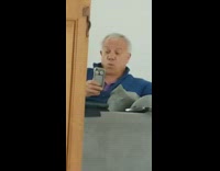 Dad makes funny faces phone couch snapchat 