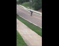 Blue shirt guy falls off skateboard downhill 