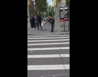 Boy carry heavy things on his back across street 