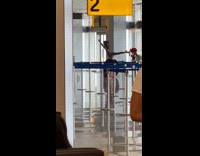 Girl handstand leg split airport guy watch