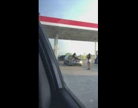 Woman legs spread hood of car photo shoot gasoline station