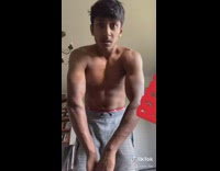 Shirtless guy flexes arms veins pop out 