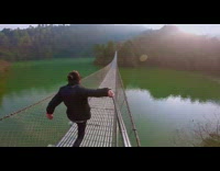 Man run and shouts on the hanging bridge