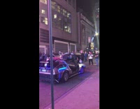 Back to the Future car replica parked on the street with doors open