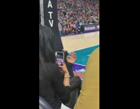 Girl photographs painted nails at basketball game 