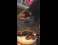 Guy holds up phone virtual birthday candle 