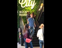 Girl poses by grass wall music city 