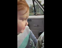 Toddler kisses baby sister 