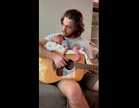 Baby lays on guitar used by father