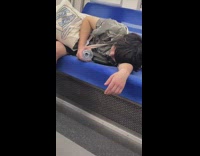 Guy sleeps on train spilling water and only having one shoe 