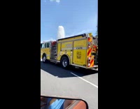 Large water spills from the broken pipe on the sidewalk