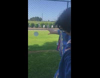 Guy pretend to control plate on fence