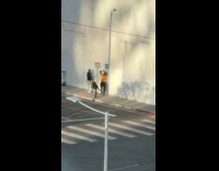 Woman poses at signage post for photo